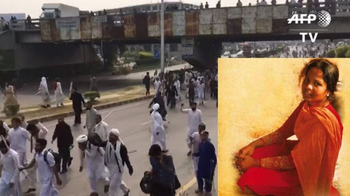 Islamic protesters march on October 31, 2018 in Pakistan after Christian mother of five Asia Bibi's (bottom right) acquittal.