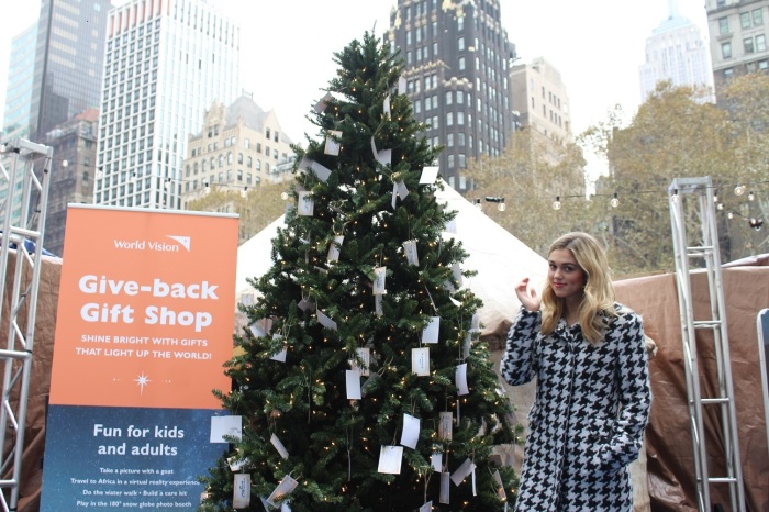 Sadie Robertson, actor and former reality television star known for the A&E show 'Duck Dynasty' is partnering with global Christian humanitarian organization World Vision this Christmas to promote their Give-back Gift Shop. She appears here next to a special Christmas tree adorned with notes reflecting prayers and hopes written by and for children around the world.
