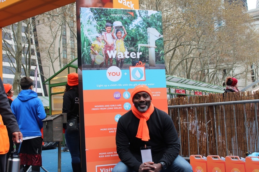 World Vision staffer, Peter Habyarimana got help as a child through the organization's work in Uganda. He appears here to promote the water walk activity at World Vision's interactive pop-up shop in Bryant Park, New York City on Monday November 26, 2018.