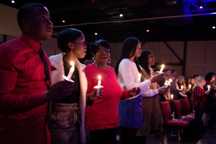 Worshipers join a candlelight Christmas service at Life.Church in 2017.