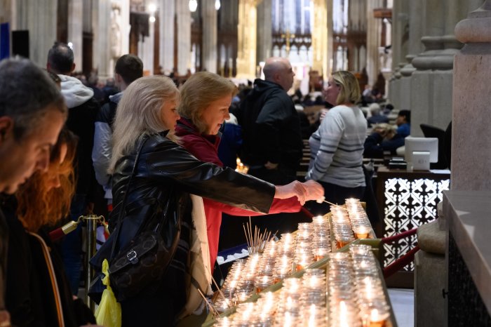 Worshipers light candles at St. Patrick's Cathedral in New York City.