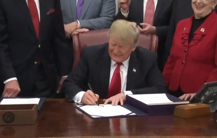 President Donald Trump signs the FIRST STEP Act in the Oval Office on Dec. 21, 2018. 