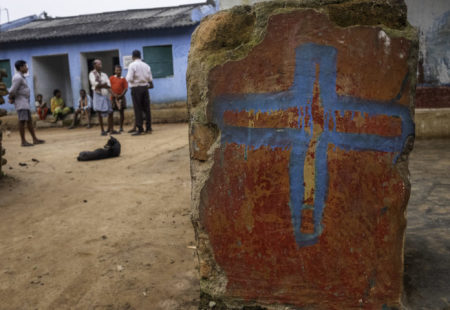 A group of Christians meet together near their rebuilt church in Kandhamal.