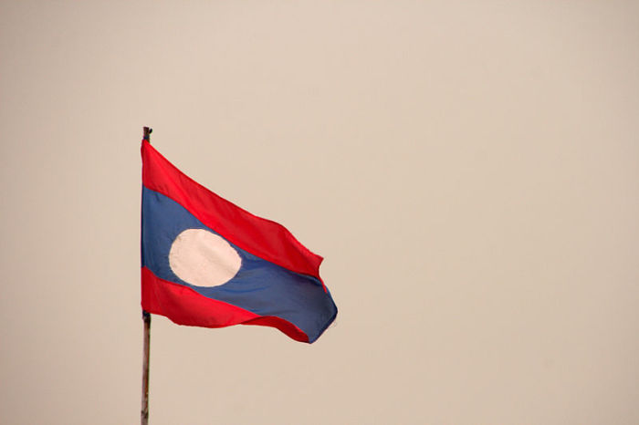 The flag of Laos waiving at the border station between Thailand and Laos at the border of Huia Xai.