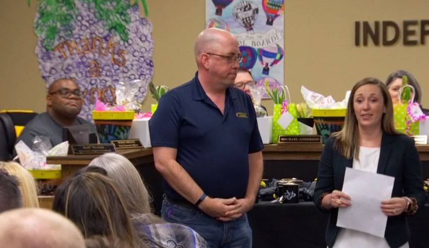 Adi Bryant (R), Royse City Independent School District's chief communications officer in Texas, recognizes Royse City UMC Pastor Chris Everson, for leading his church into paying of the lunch debt for more than 200 students in the district. | Screenshot: NBC 5