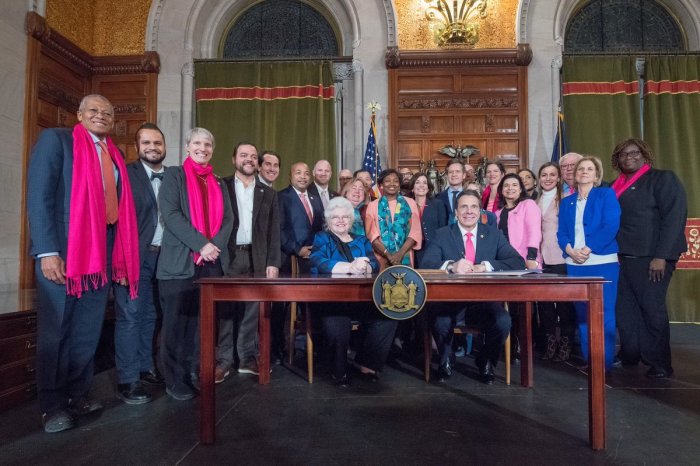 New York Gov. Andrew Cuomo (seated R), poses with state Senate Majority Leader Andrea Stewart-Cousins (C), Sarah Weddington (seated L), the lawyer nationally known for successfully arguing the winning side of the Roe v. Wade case, and others after signing the controversial Reproductive Health Act into law on January 22, 2019.