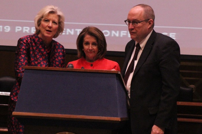 Speaker of the House Nancy Pelosi (M), CCCU President Shirley Hoogstra (L) and National Association of Evangelical's Galen Carey (R) gather at the podium during the Council for Christian Colleges and Universities 2019 Presidents Conference hosted on Capitol Hill in Washington, D.C. on Jan. 30, 2019.