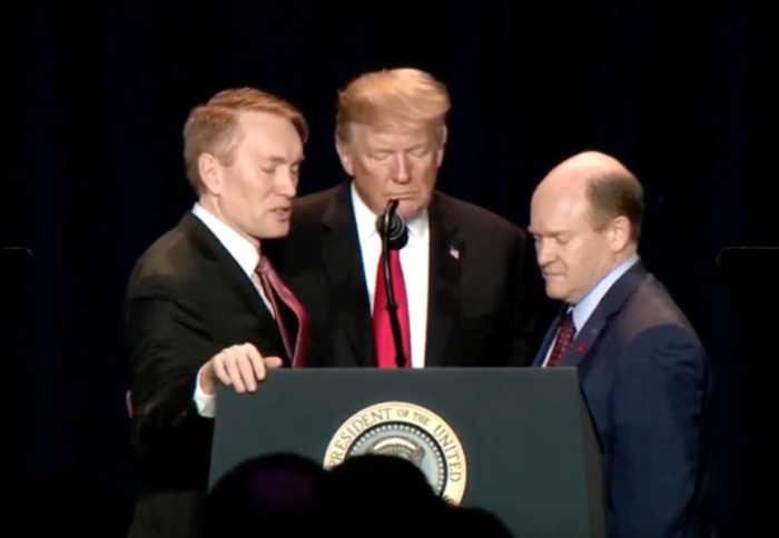 Sen. James Lankford (L) and Sen. Chris Coons (R) prays for President Donald Trump at the National Prayer Breakfast on Feb. 7, 2019.