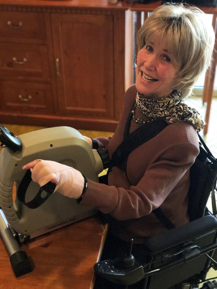 Joni Eareckson Tada, who was diagnosed with cancer in November, demonstrates her arm exercise-cycle.