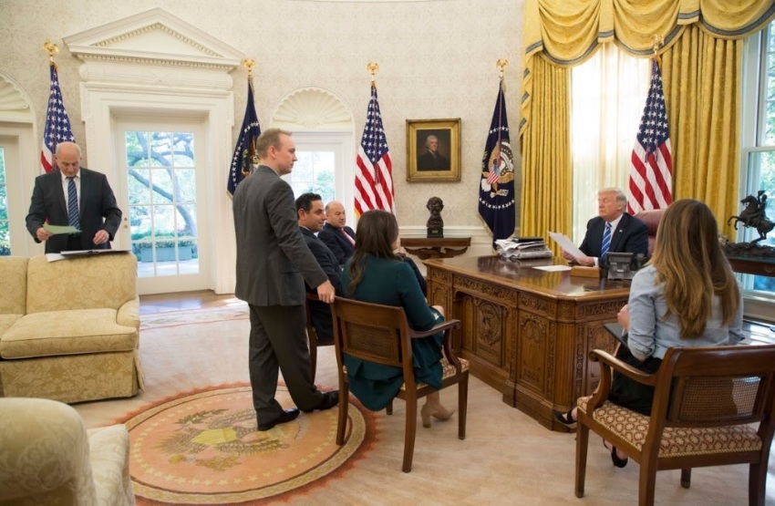 Cliff Sims (standing, facing the president), in a meeting with President Donald Trump and other White House staff, prepping the commander-in-chief for an interview about his tax reform plan.