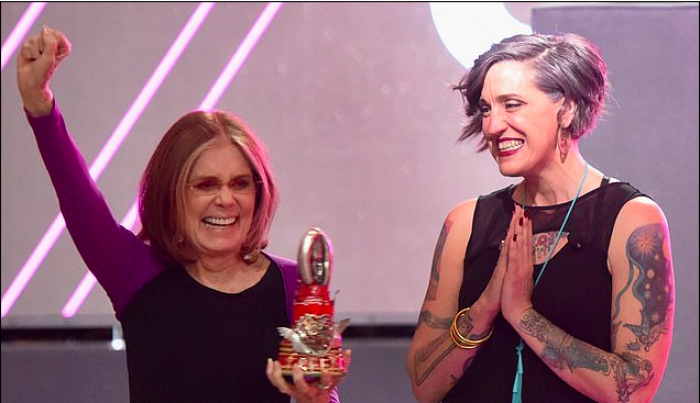 Liberal Lutheran pastor and author Nadia Bolz-Weber presents pro-abortion second-wave feminist Gloria Steinem with a sculpture made of melted-down purity rings.