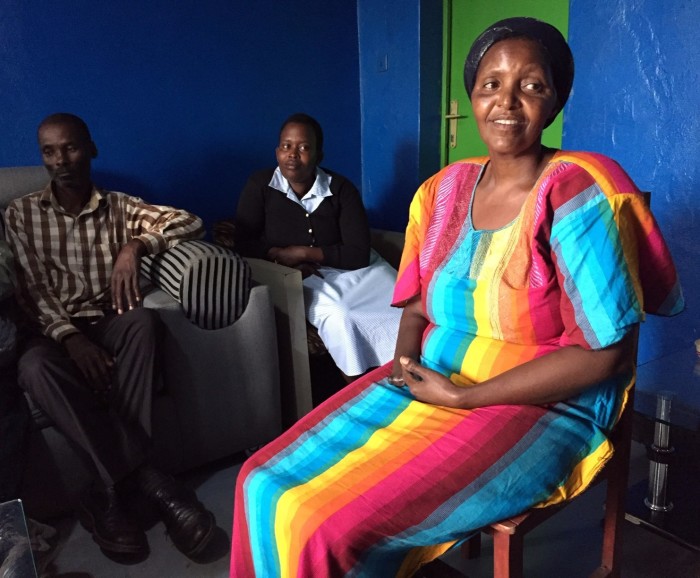 Alice Mukarurinda (R) shares her personal experiences as a Tutsi during the Rwandan genocide of 1994 with a group of reporters on Feb. 18, 2019, at her home in the village of Nyamata, Rwanda. To her left is World Vision staffer Goreth Mbabazi. To Mbabazi's left is Emmanuel Ndayisaba, the man who cut off Mukarurinda's hand. 