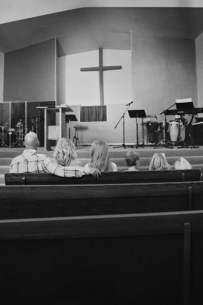 Morgan Idleman (2nd from L) sits with her family, including Pastor Shane Idleman, at church.