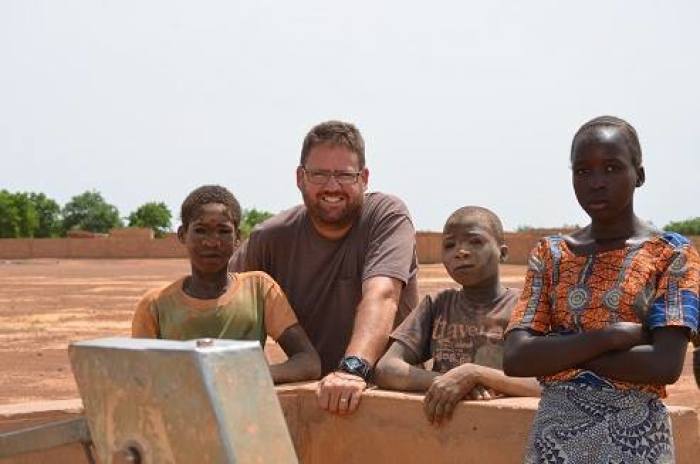 Michael Riddering poses for a picture with children from West Africa in this photograph posted to Facebook in 2013.