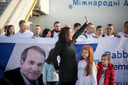 Yael Eckstein waves to an onlooker as she welcomes Jewish migrants from Ukraine to their new home in Israel at Ben-Gurion International Airport in February 2019. A total of 116 families were transported to Israel on board the "Yechiel Eckstein Memorial Flight."