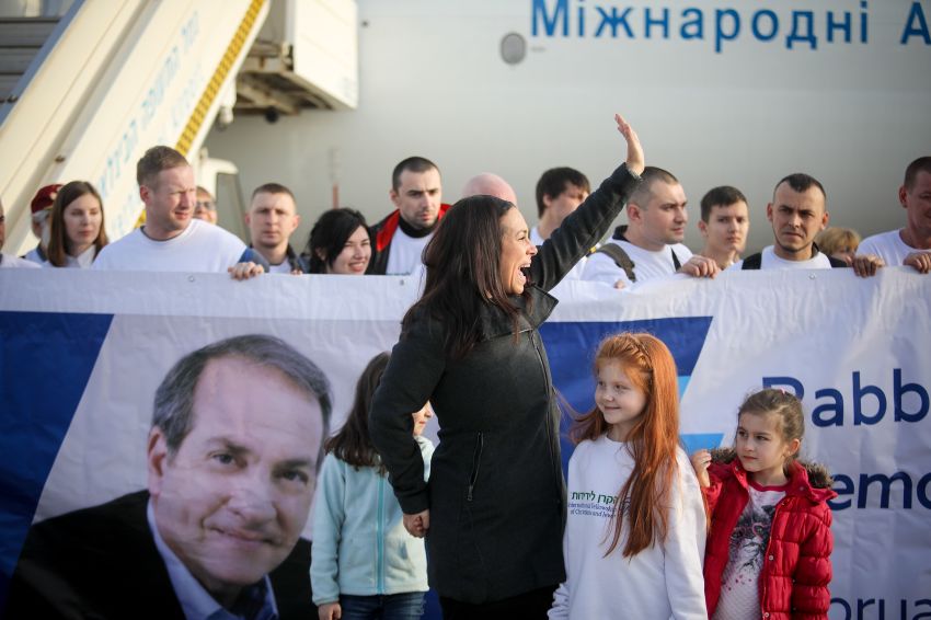 Yael Eckstein waves to an onlooker as she welcomes Jewish migrants from Ukraine to their new home in Israel at Ben-Gurion International Airport in February 2019. A total of 116 families were transported to Israel on board the "Yechiel Eckstein Memorial Flight."