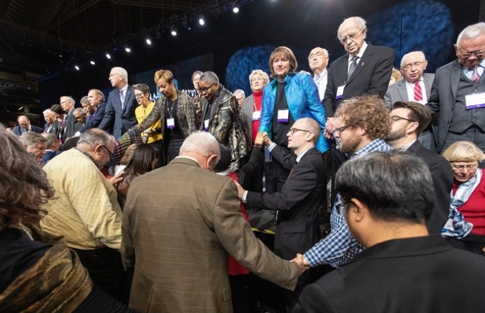 Delegates and bishops pray before a key vote on church policies about homosexuality during the 2019 United Methodist General Conference in St. Louis. 