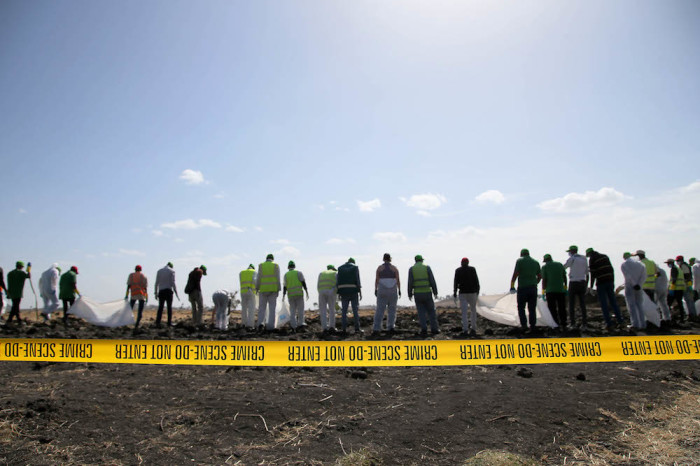 Forensics investigators and recovery teams collect personal effects and other materials from the crash site of Ethiopian Airlines Flight ET 302 on March 12, 2019 in Bishoftu, Ethiopia. All 157 passengers and crew perished after the Ethiopian Airlines Boeing 737 Max 8 Flight came down six minutes after taking off from Bole Airport in Addis Ababa. 