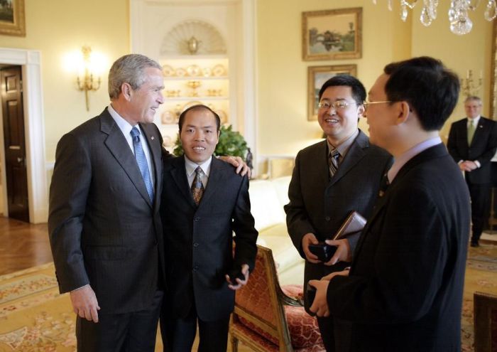 President George W. Bush meets with Chinese Human Rights activists Li Baiguang, Wang Yi, and Yu Jie in the Yellow Oval Room of the White House in Washington, DC on May 11, 2006. 