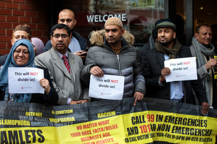 People hold up signs with the words 'This will not divide us' as they attend a vigil at the East London Mosque for the victims of the New Zealand mosque attacks on March 15, 2019 in London, England. Patrols have been increased after 49 people were killed in mass shootings at two mosques in central Christchurch, New Zealand, on Friday. (