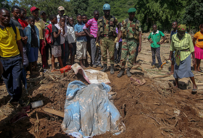 A blanket covers a body of someone killed days earlier by Cyclone Idai in Chipinge, Zimbabwe, on March 20, 2019. Zimbabwean authorities have said more than 100 people have died and hundreds of others are missing in that country after the storm caused landslides and flooding. The number of dead and displaced is even higher in neighboring Mozambique, where there was widespread flooding. 