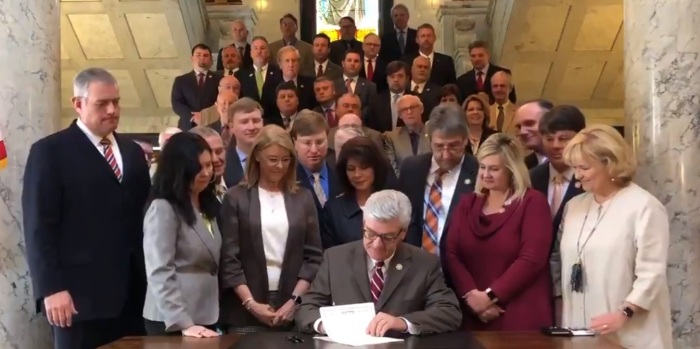 Mississippi Governor Phil Bryant signs a bill into law in March 2019 that bans abortions once a fetal heartbeat is detected. 