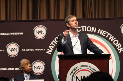 Former Texas Rep. Beto O'Rourke (podium) who is one of several 2020 Democrat presidential candidates, speaks at the National Action Network convention in New York City on Wednesday April 3, 2019. Civil rights activist and NAN founder Al Sharpton listens intently.