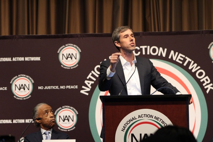 Former Texas Rep. Beto O'Rourke (podium), who is one of several 2020 Democrat presidential candidates, speaks at the National Action Network convention in New York City on Wednesday, April 3, 2019. Civil rights activist and NAN founder Al Sharpton listens nearby.