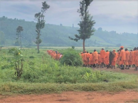 Prisoners prepare for manual labor in the fields of the Southern Province of Rwanda.