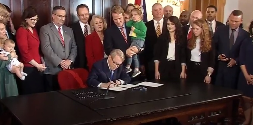 Ohio Governor Mike DeWine signs a bill into law on Thursday, April 11, 2019, that bans abortions on unborn babies for which a heartbeat can be detected.