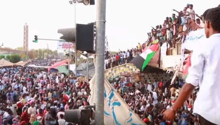 Protesters in Sudan in April 2019 amid the overthrow of longtime president Omar al-Bashir, who has been accused of engaging in war crimes in the Darfur region.