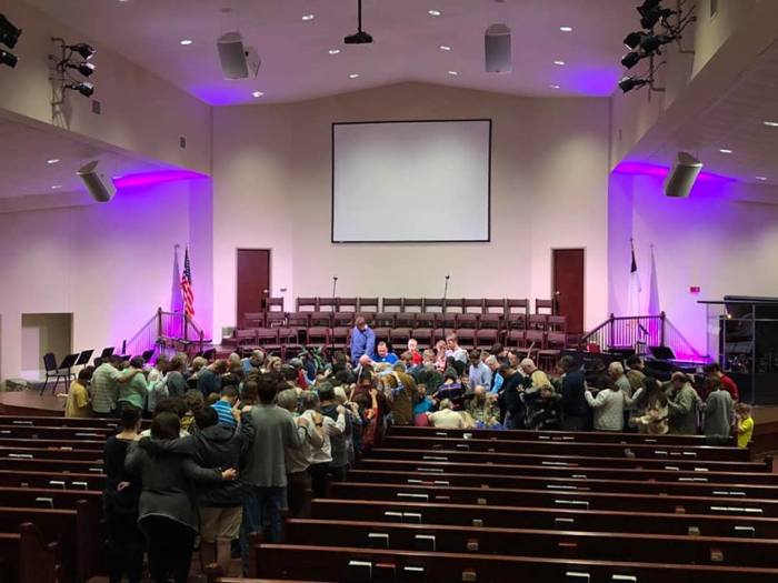 Members of Chapel Hill Baptist Church in Northport, Ala., pray for their late pastor, James W. Nichols, on Sunday, April 14, 2019.