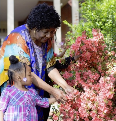 Sharonell Fulton enjoys time in the garden with one of her foster children. 