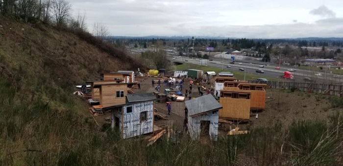 Volunteers work to construct Agape Village on the 11-acre campus of the Central Church of the Nazarene in Portland, Oregon in March 2019. 