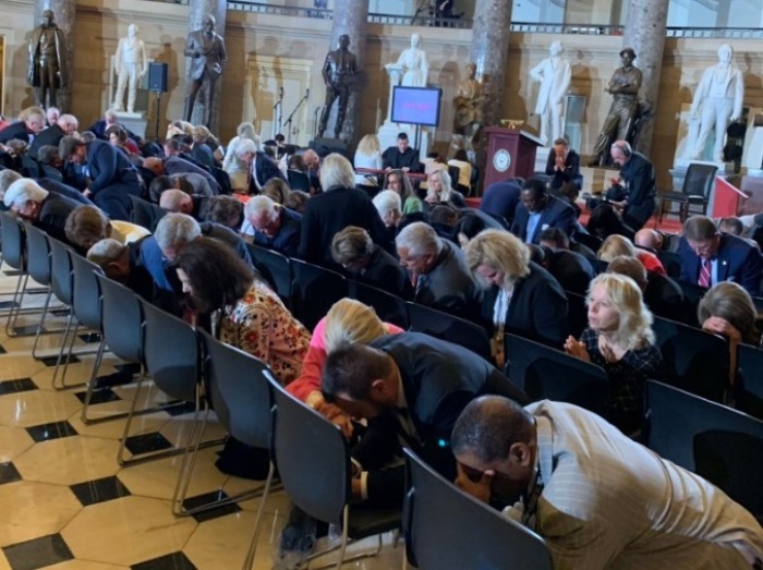 Participants in the National Day of Prayer observance at the U.S. Capitol Statuary Hall in Washington, D.C. kneel in prayer on May 2, 2019. 