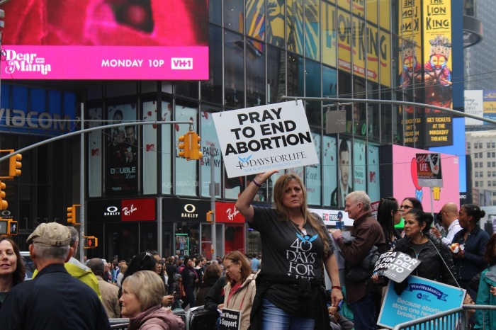 Born-again Christian Cindy Fiore lifts an anti-abortion placard at the 'Alive From New York' event hosted by Focus on the Family in Times Square New York City on Saturday, May 4, 2019.