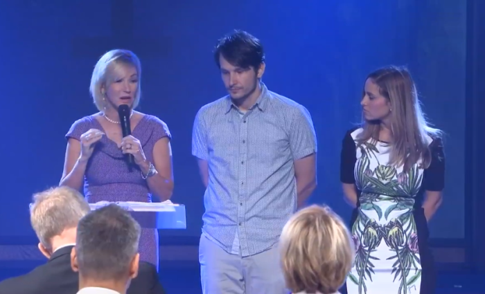 Paula White (L) announces an official change to the name of her New Destiny Christian Center in Apopka, Florida, on Sunday and installs her son, Brad Knight (C), as senior pastor along with his wife, Rachel (R). 