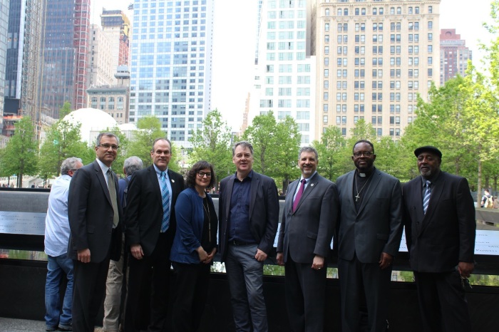 At the south pool of the 9/11 Memorial in New York City on Friday May 17, 2019 (from L-R) are Rev. Dr. Trace Haythorn , executive director and CEO of the Association for Clinical Pastoral Education; Rev. Matthew Crebbin of Newtown Congregational Church; Kirsten Kelly, senior producer for Transform Films and Odyssey Impact; Nick Stuart, CEO of Odyssey Impact; Cantor Michael Sochet, senior clergy Temple Rodef Shalom; Sam Saylor Sr., senior pastor of the Gardner Memorial AME Zion Church of Springfield, Mass.; and Rev. Henry Brown of Mothers United Against Violence.
