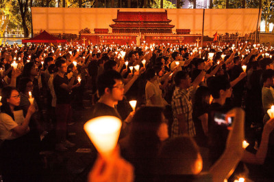 Thousands of people hold candles during a candlelight vigil on June 4, 2016, in Hong Kong to commemorate the killing of protesters in Beijing's Tiananmen Square in 1989. 