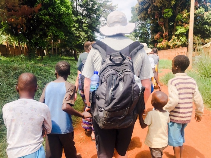 Jody Jennings, VP of campus ministries at North Greenville University, leads children to VBS in Hoima, Uganda.