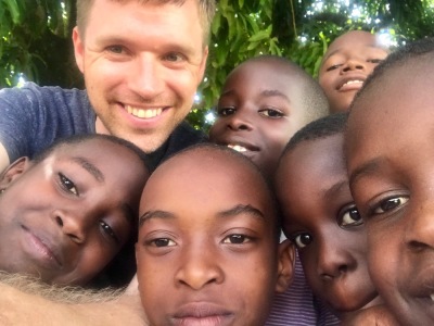 Joshua Gilmore takes a photo with children in Hoima, Uganda.