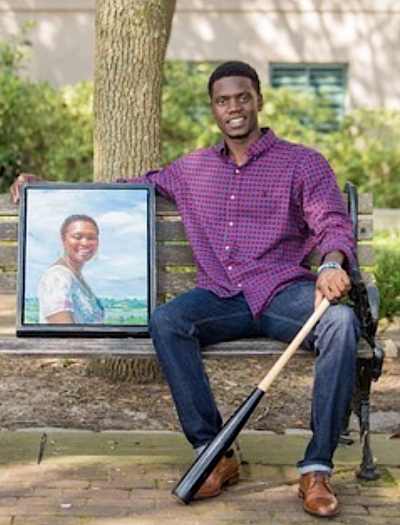 Chris Singleton poses with a photo of his mother, Sharonda Coleman-Singleton who was gunned down in the 2015 Emanuel AME Church shooting. 