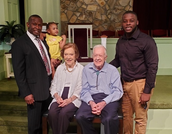 Longtime members of the Maranatha Baptist Church in Plains, Ga., former President Jimmy Carter and his wife Rosalynn Carter (C), poses with the first black pastor of their predominantly white church The Rev. Tony Lowden and his daughter Tabitha (L) as well as another church member, Brandon B. Thomas (R). 