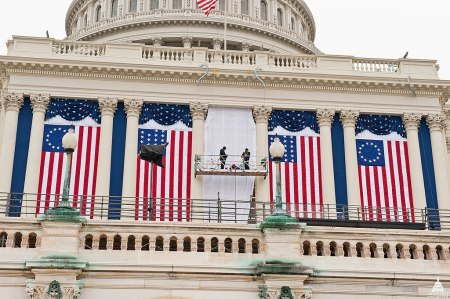 The "Betsy Ross" design displayed at the second inauguration of Barack Obama. Workers hang historic US flags at the US Capitol building for the 2012 Presidential Election, January 4, 2012.