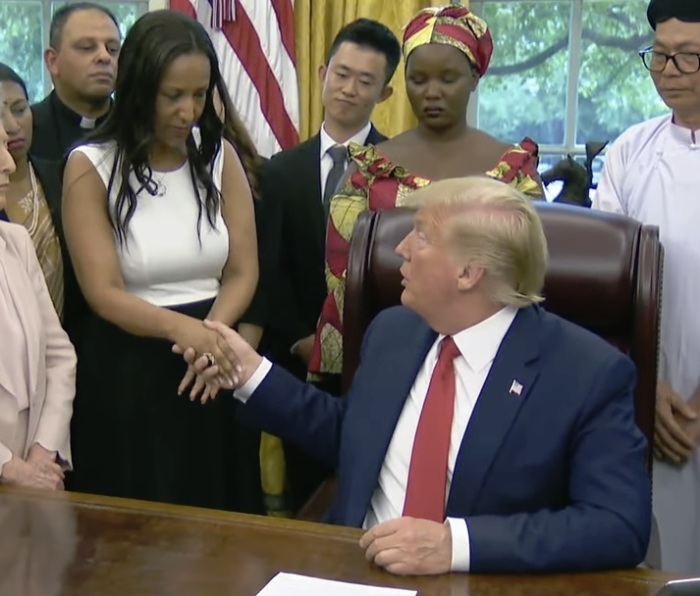 Eritrean Christian Helen Berhane shakes the hand of President Donald Trump during a meeting at the White House on July 17, 2019 in Washington, D.C. 