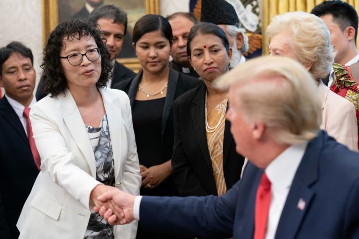 Falun Gong practitioner Yuhua Zhang shakes the hand of President Donald Trump during a visit to the White House in Washington, D.C. on July 17, 2019. 