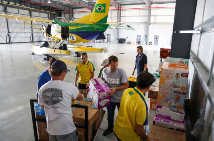 Members of Convoy of Hope's International Disaster Services team, along with volunteers, unpack relief supplies from a chartered plane after arriving in Nassau, Bahamas, Sept. 7, 2019. 
