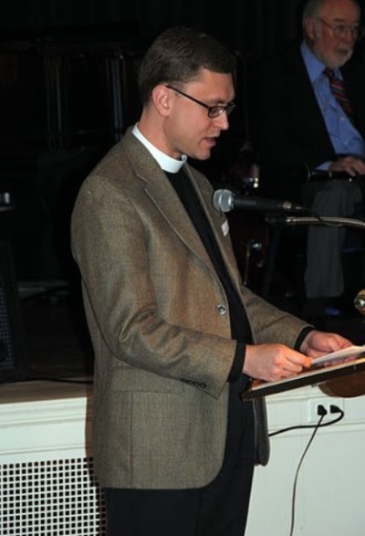 The Rev. Gregory Lisby of Christ Church gives an invocation at a Community Meals, Inc. event in 2011. 