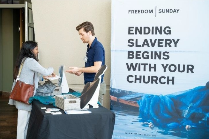 Freedom Sunday attendee speaks with an International Justice Mission staff member to learn more about the organization and opportunities to give.