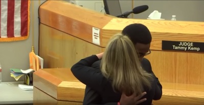 Brandt Jean, brother of Botham Jean, embraces former Dallas, Texas police officer Amber Guyger, the women who murdered his brother, following impact statements given in court on Wednesday, Oct. 2, 2019.